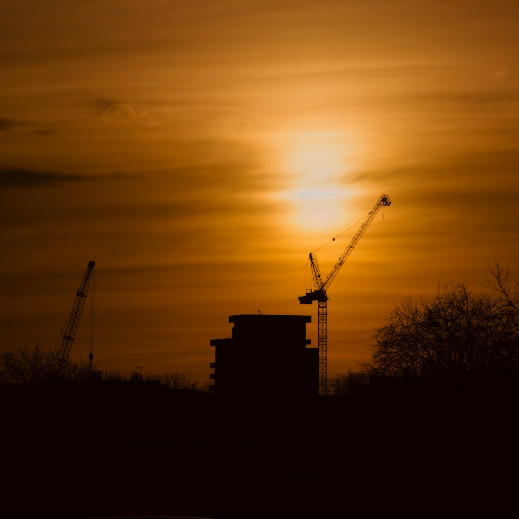 Multifamily building under construction at sunset